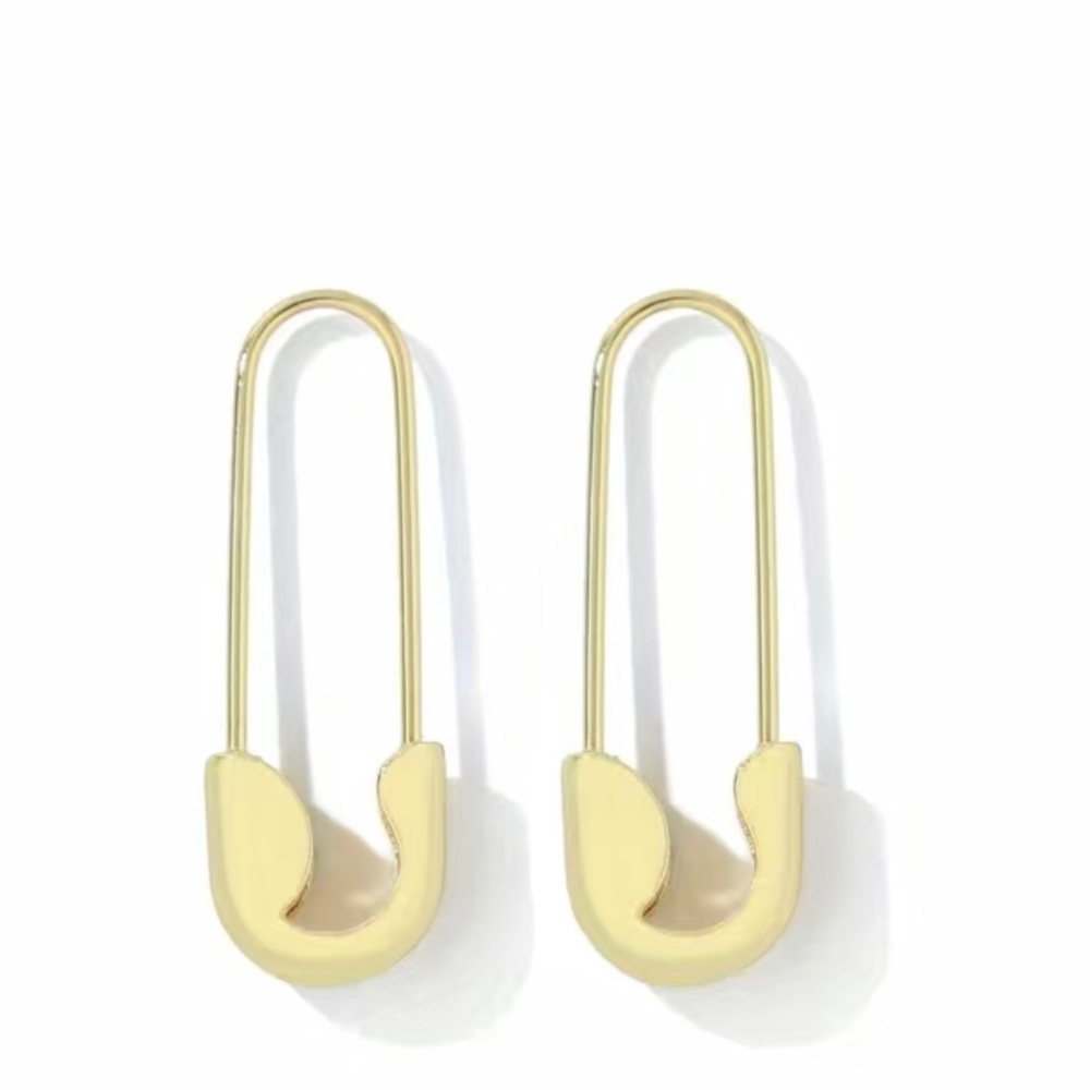 Gold colored safety pin earrings.